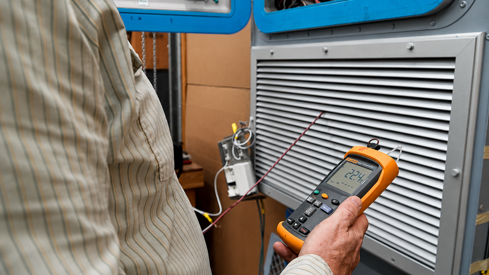 Engineer reviewing CAD drawings and 3D models for HVAC system design