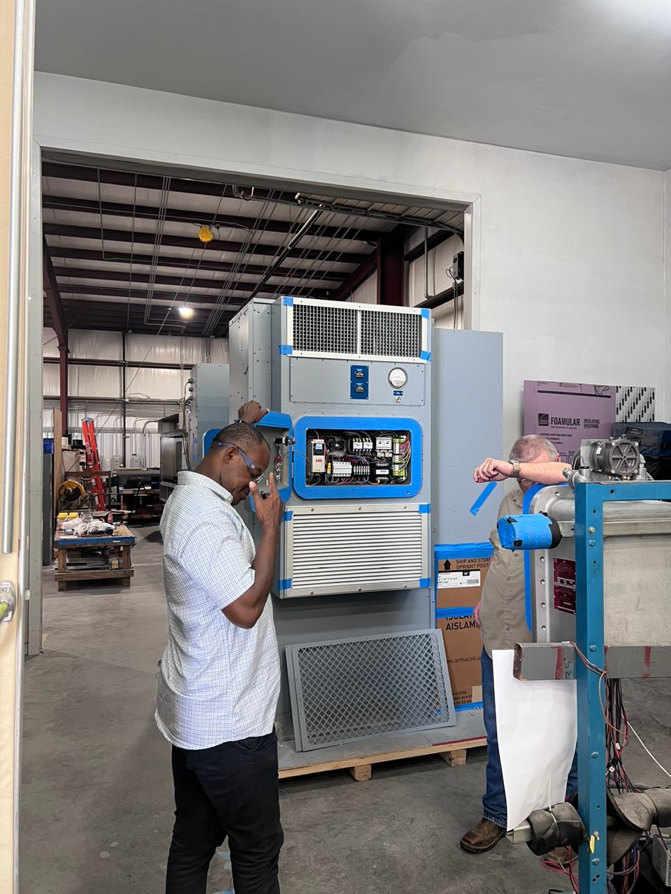 Engineer reviewing technical documents and data at an industrial facility