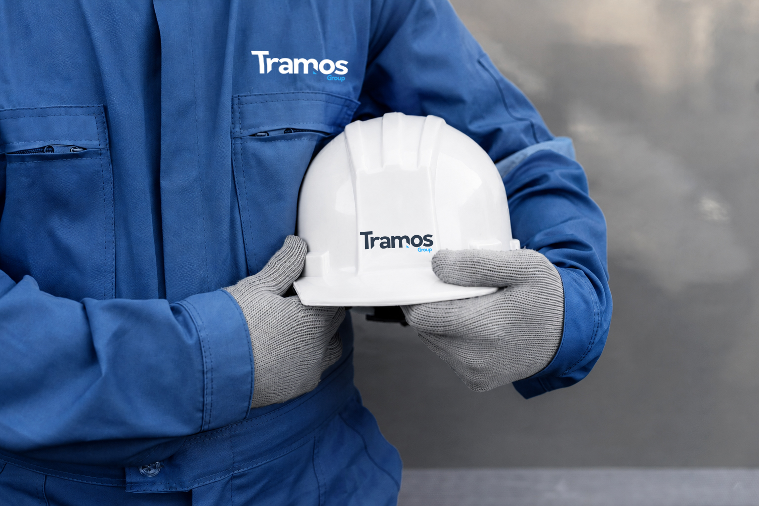 construction worker in helmet and reflective vest inspecting a large industrial blueprint on a site with steel beams